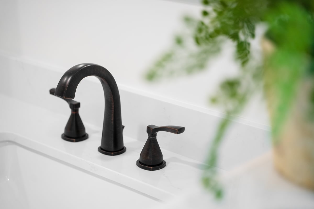 Luxurious dark metal faucet on quartz countertop by Trinity Homes AZ in Cave Creek, AZ