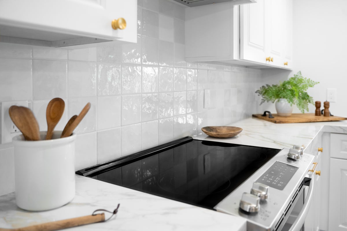 Smooth electric cooktop with marble counters in custom kitchen by Trinity Homes AZ in Arcadia, AZ