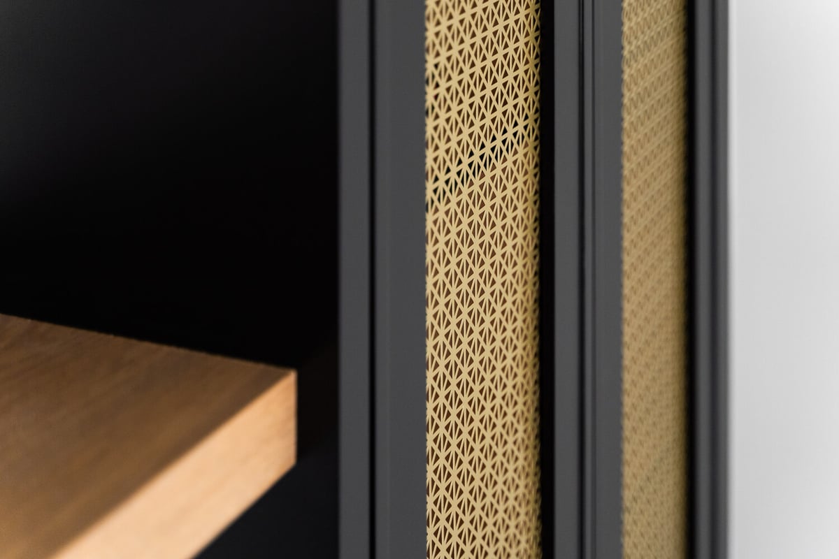 Close-up of black cabinetry with golden lattice design by Trinity Homes AZ, Paradise Valley, AZ