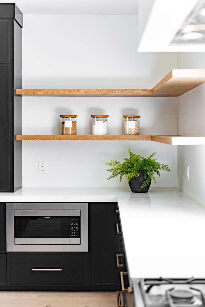 Corner shelving and built-in microwave in a modern custom kitchen by Trinity Homes AZ, Scottsdale, AZ