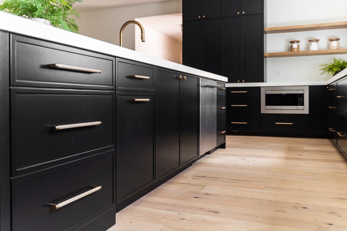 Custom kitchen island with storage drawers and wood flooring by Trinity Homes AZ in Scottsdale, AZ