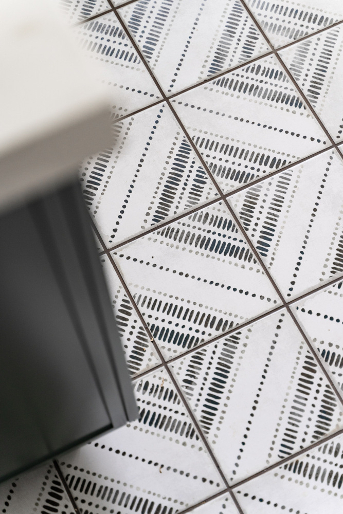 Decorative geometric tile flooring detail in custom laundry room by Trinity Homes AZ in Scottsdale, AZ