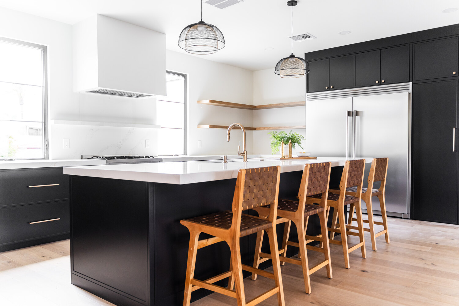 Elegant black and white kitchen renovation by Trinity Homes AZ featuring custom island in Scottsdale, AZ Elegant black and white kitchen renovation by Trinity Homes AZ featuring custom island in Scottsdale, AZ