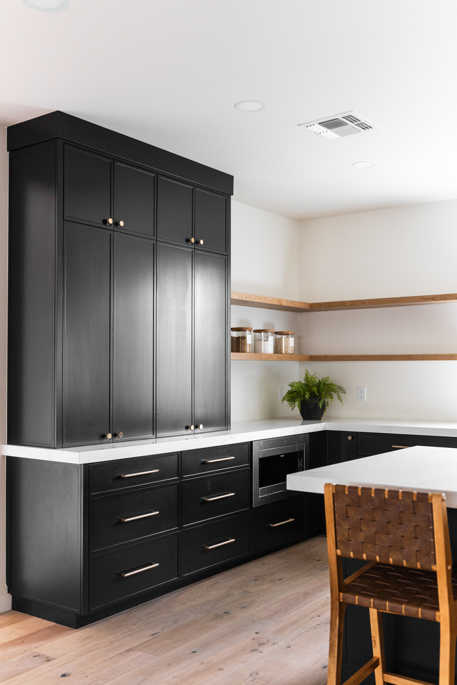 Sleek black cabinetry and minimalist kitchen design by Trinity Homes AZ in Scottsdale, AZ