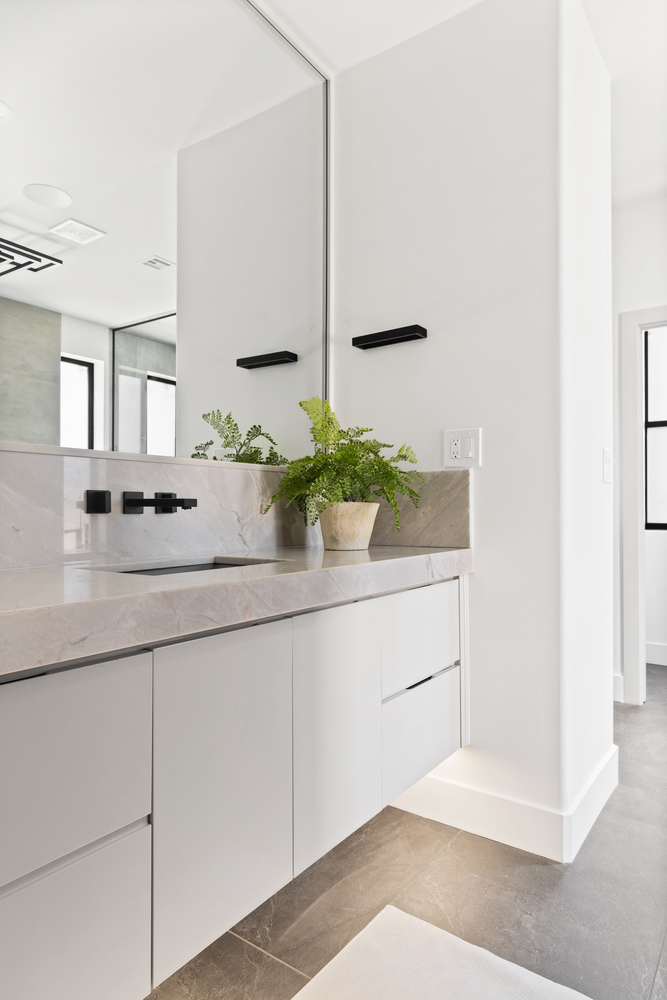 Minimalist custom bath design with sleek surfaces and soft lighting by Trinity Homes AZ in Mesa
