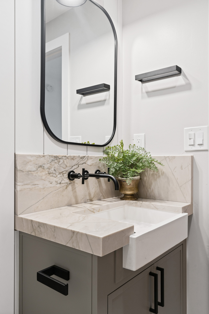 Modern powder room with marble sink and black hardware in a Paradise Valley, AZ home by Trinity Homes AZ