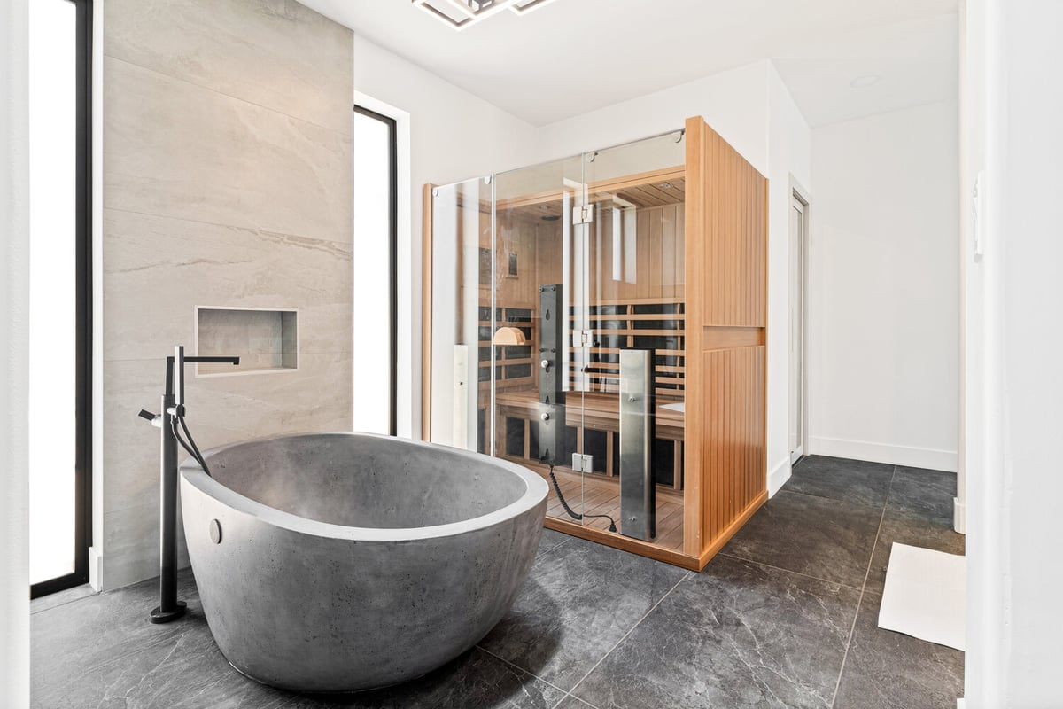 Trinity Homes AZ delivers luxury with a concrete tub and wood sauna in this Phoenix custom home