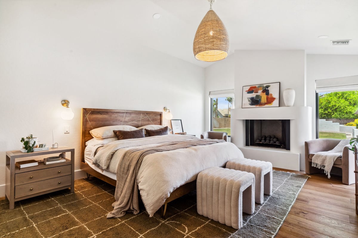 Cozy modern bedroom with fireplace in a whole home renovation by Trinity Homes in Gilbert, AZ
