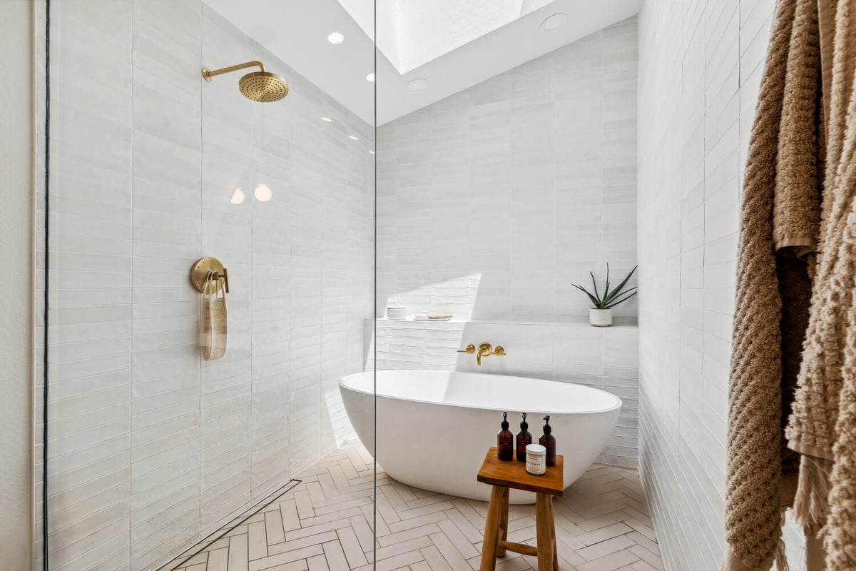 Freestanding tub under skylight in luxurious Trinity Homes master bath remodel in Gilbert, AZ