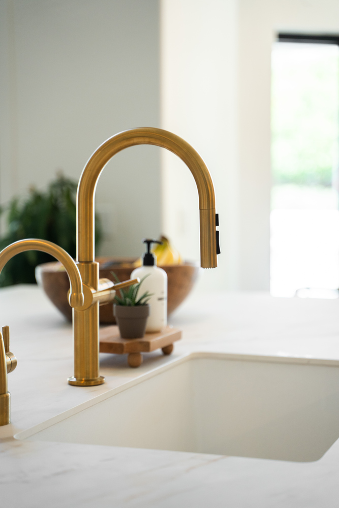Modern gold kitchen faucet in a custom whole home remodel by Trinity Homes in Gilbert, AZ