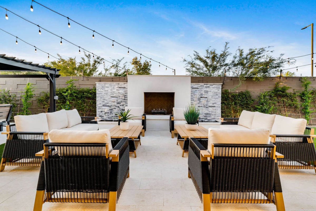 Backyard remodel in Phoenix by Trinity Homes featuring fire pit lounge and pergola
