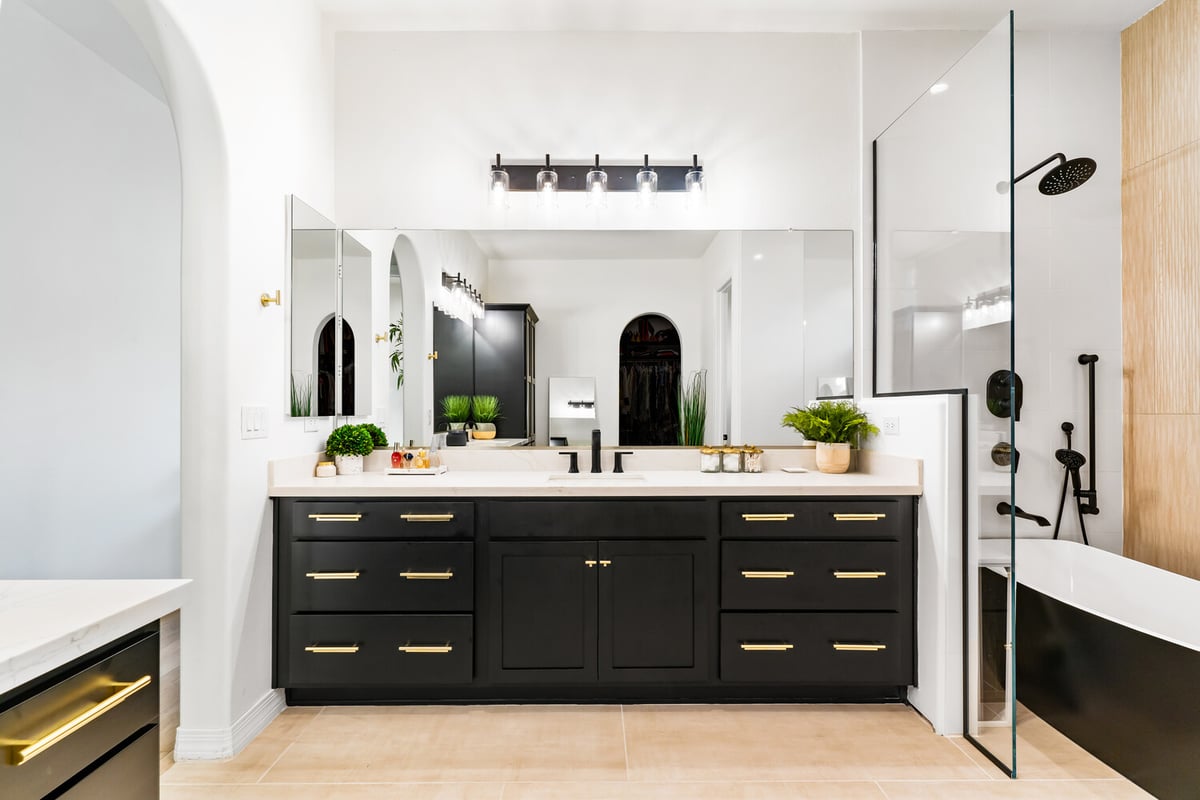 Bathroom remodel with contemporary black double vanity and mirror wall by Trinity Homes in Phoenix, AZ