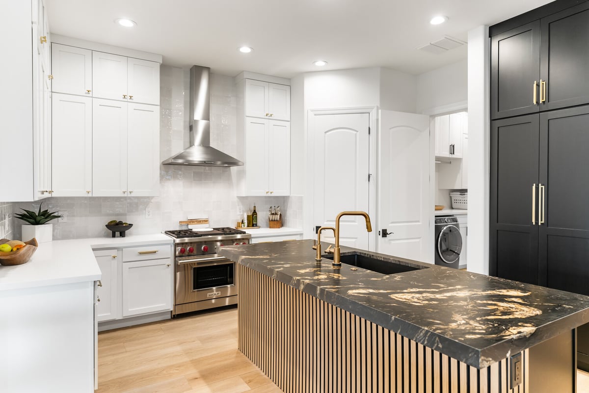 Contemporary kitchen remodel in Phoenix by Trinity Homes featuring black and gold island