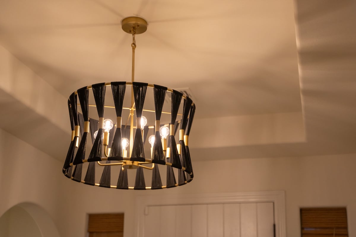 Elegant black and gold chandelier in Phoenix, AZ remodel by Trinity Homes