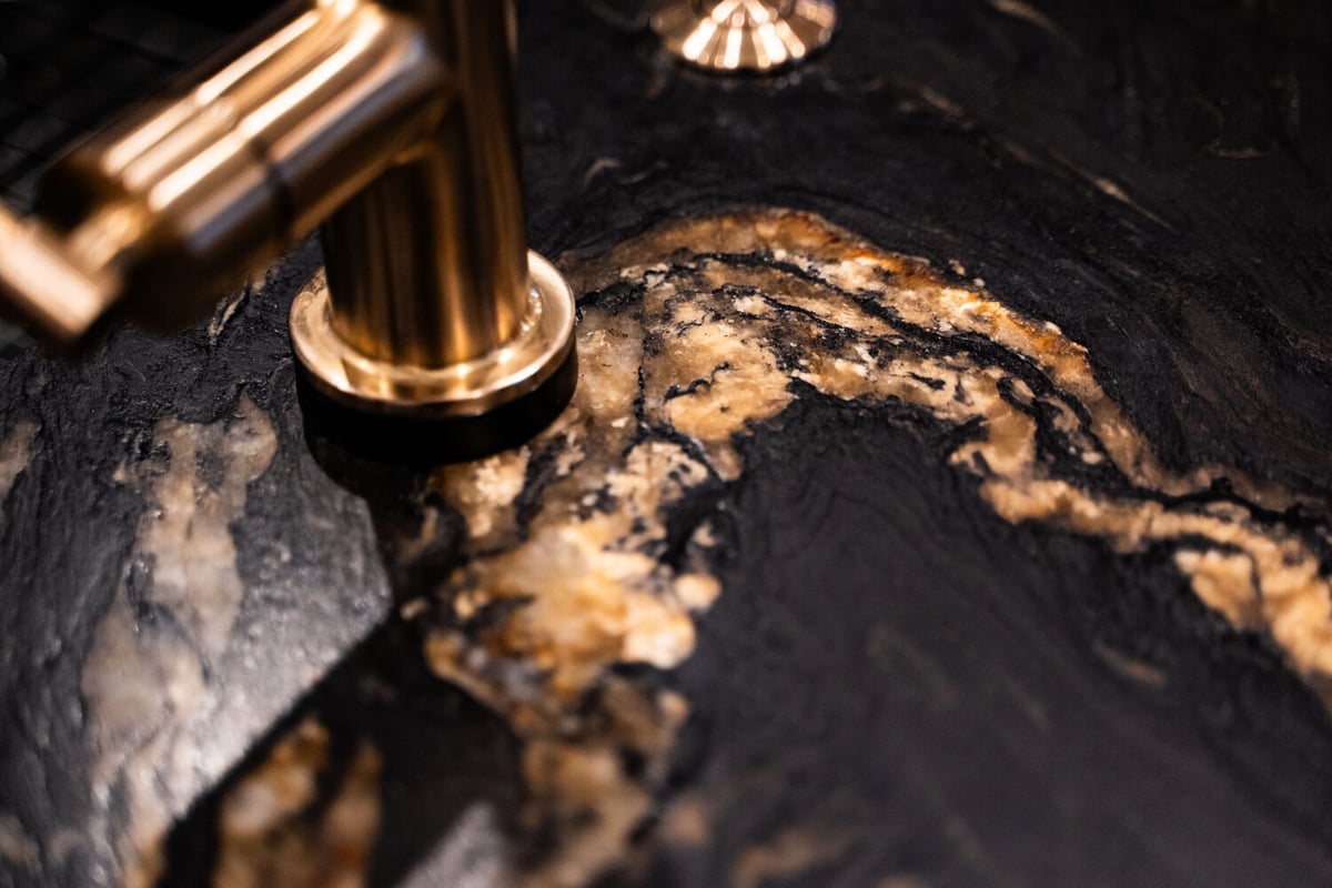Marble-inspired black countertop surface in Phoenix kitchen remodel by Trinity Homes