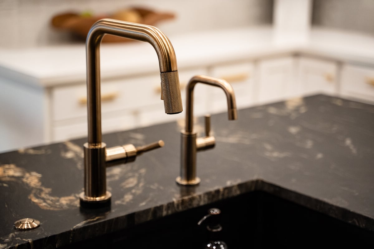 Matte black bathroom faucet on white vanity in Phoenix remodel by Trinity Homes