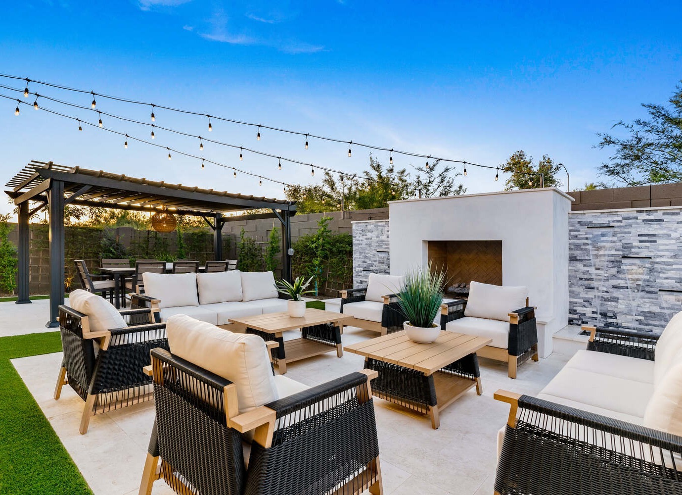 Phoenix patio remodel by Trinity Homes with cushioned seating and fireplace accent wall