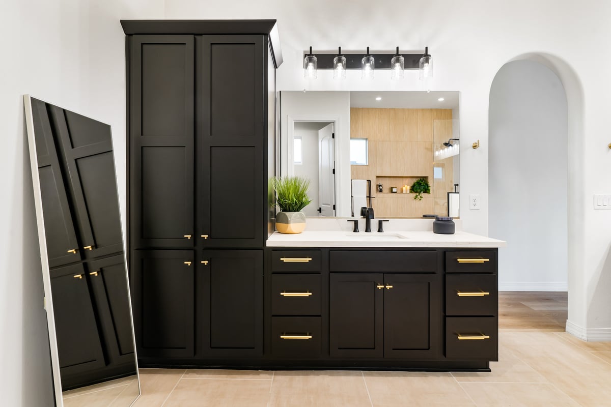 Trinity Homes bathroom remodel with tall black cabinet and dual vanity in Phoenix, AZ