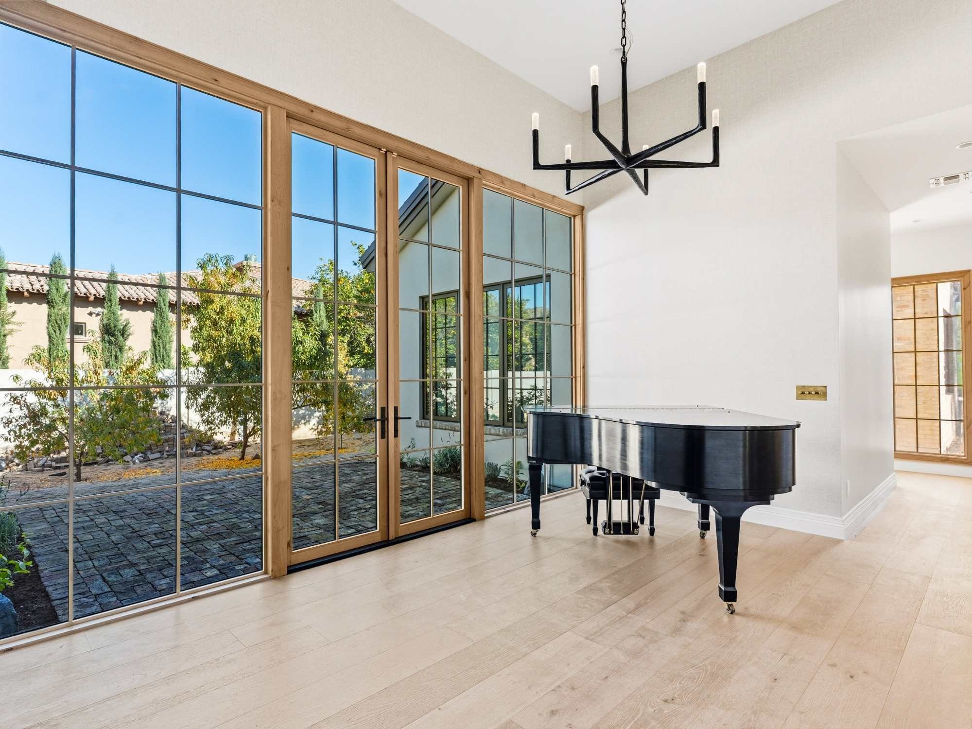 Large stain-grade windows with wood frames in a custom home by Trinity Homes AZ