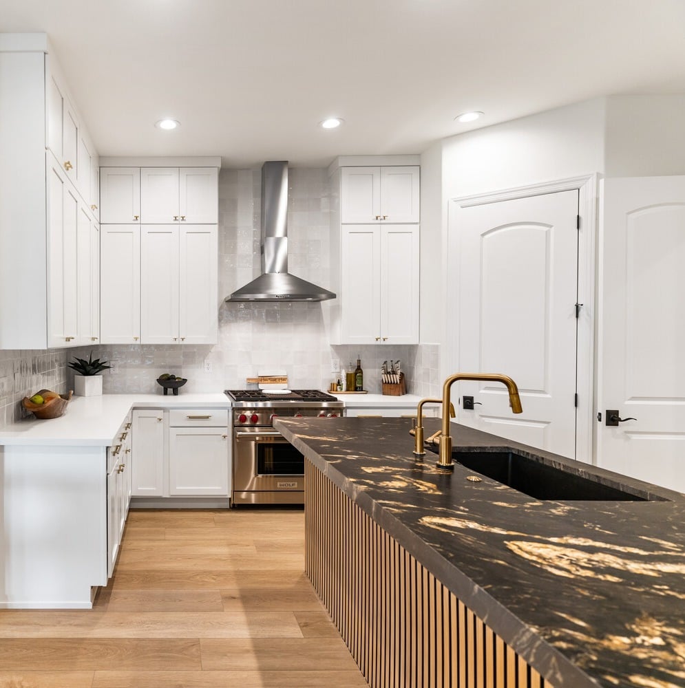 Modern kitchen remodel in Phoenix, AZ by Trinity Homes with black and gold waterfall island
