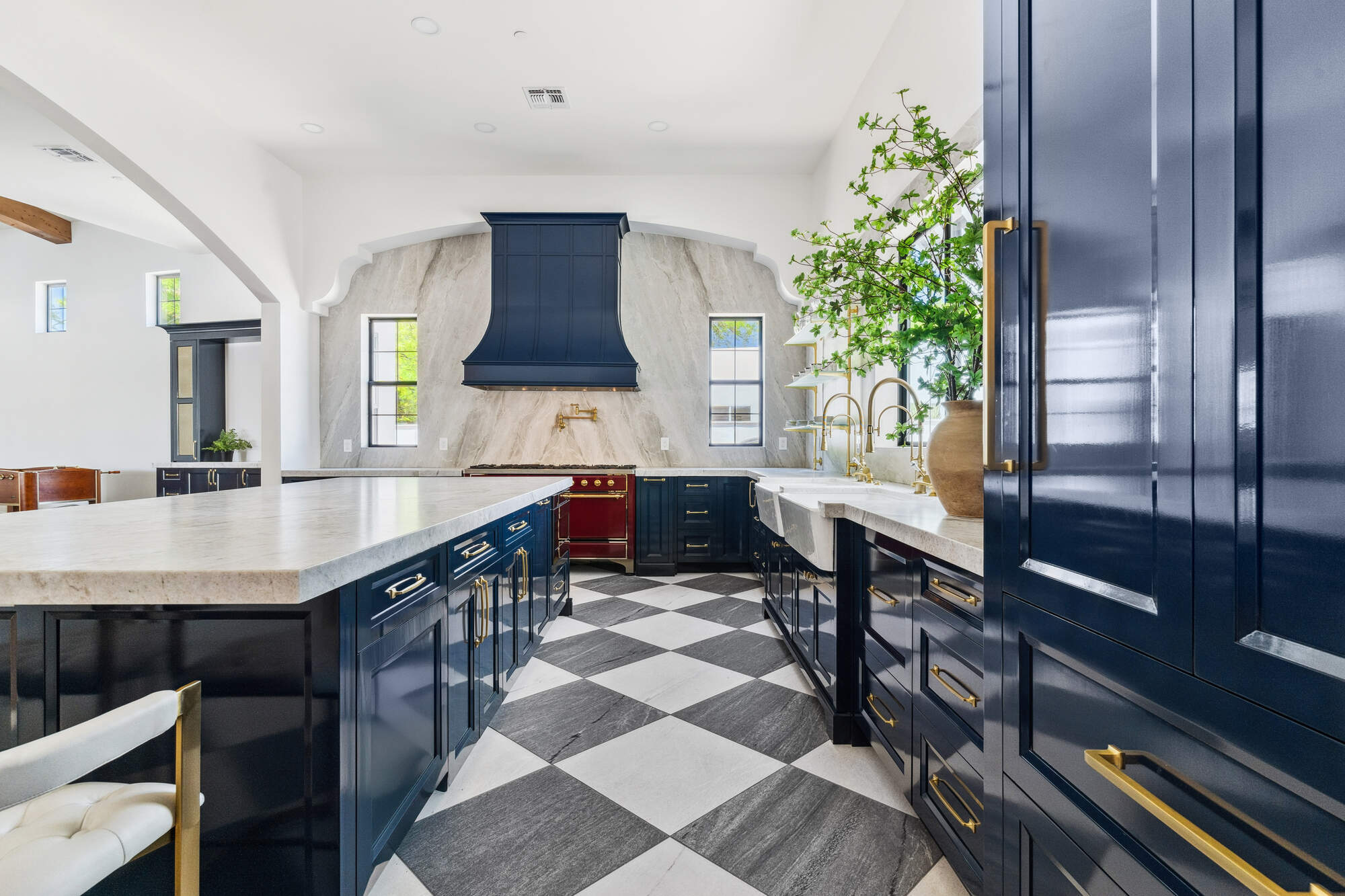 Bright open-concept kitchen remodel in Scottsdale with checkerboard tile and navy cabinetry by Trinity Homes