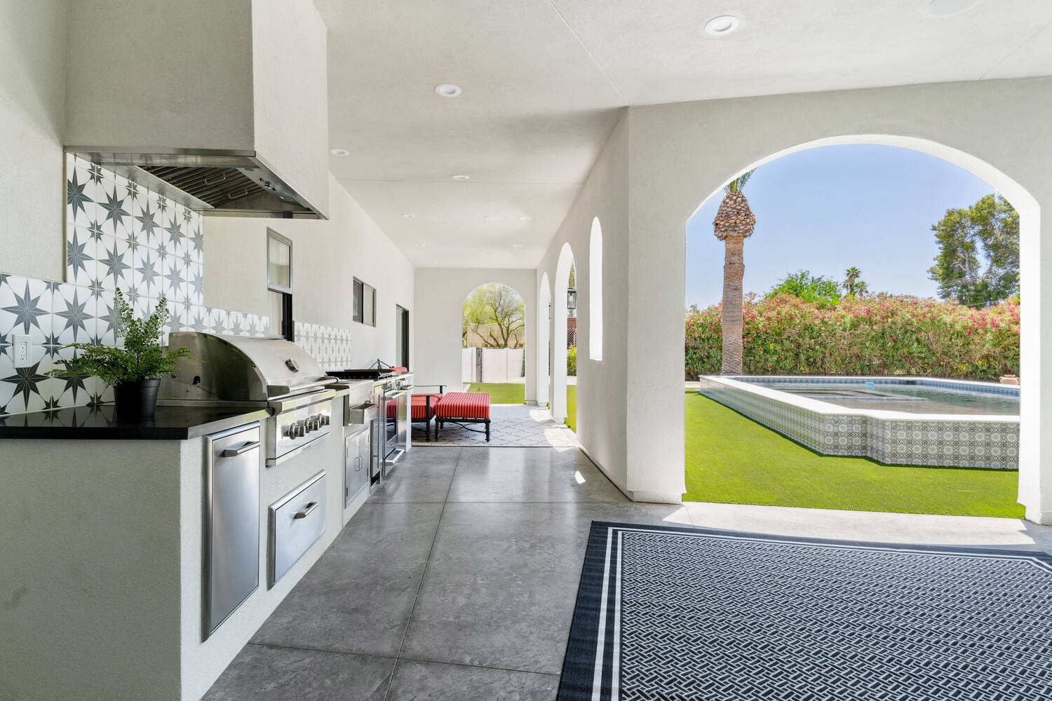 Outdoor kitchen view extending to pool in Phoenix whole home remodel by Trinity Homes