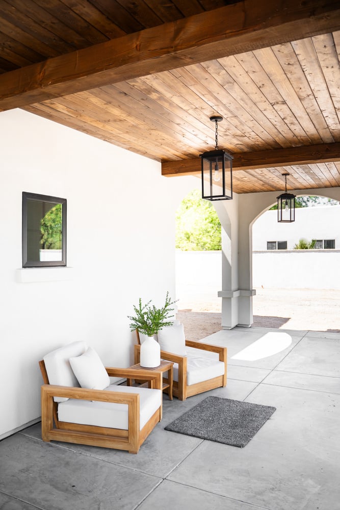 Outdoor seating area beneath a wood-paneled ceiling in a Trinity Homes Scottsdale whole home remodel