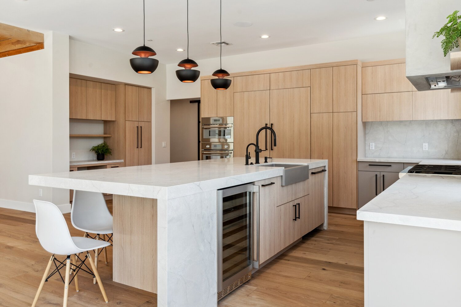 Kitchen remodel with island seating and built-in wine cooler by Trinity Homes in Paradise Valley