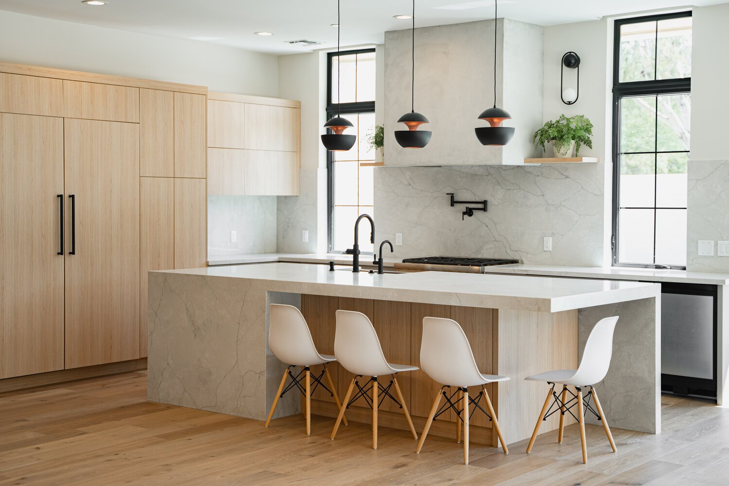 Modern kitchen remodel with light wood cabinetry and marble island in Paradise Valley home by Trinity Homes