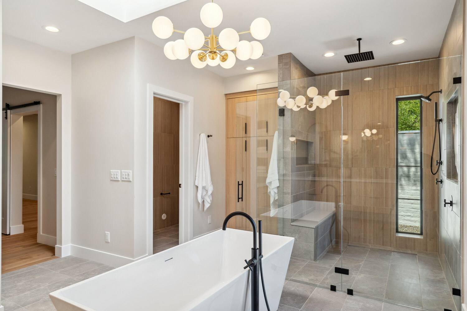 Open-concept luxury bathroom with freestanding tub and large walk-in shower by Trinity Homes in Paradise Valley