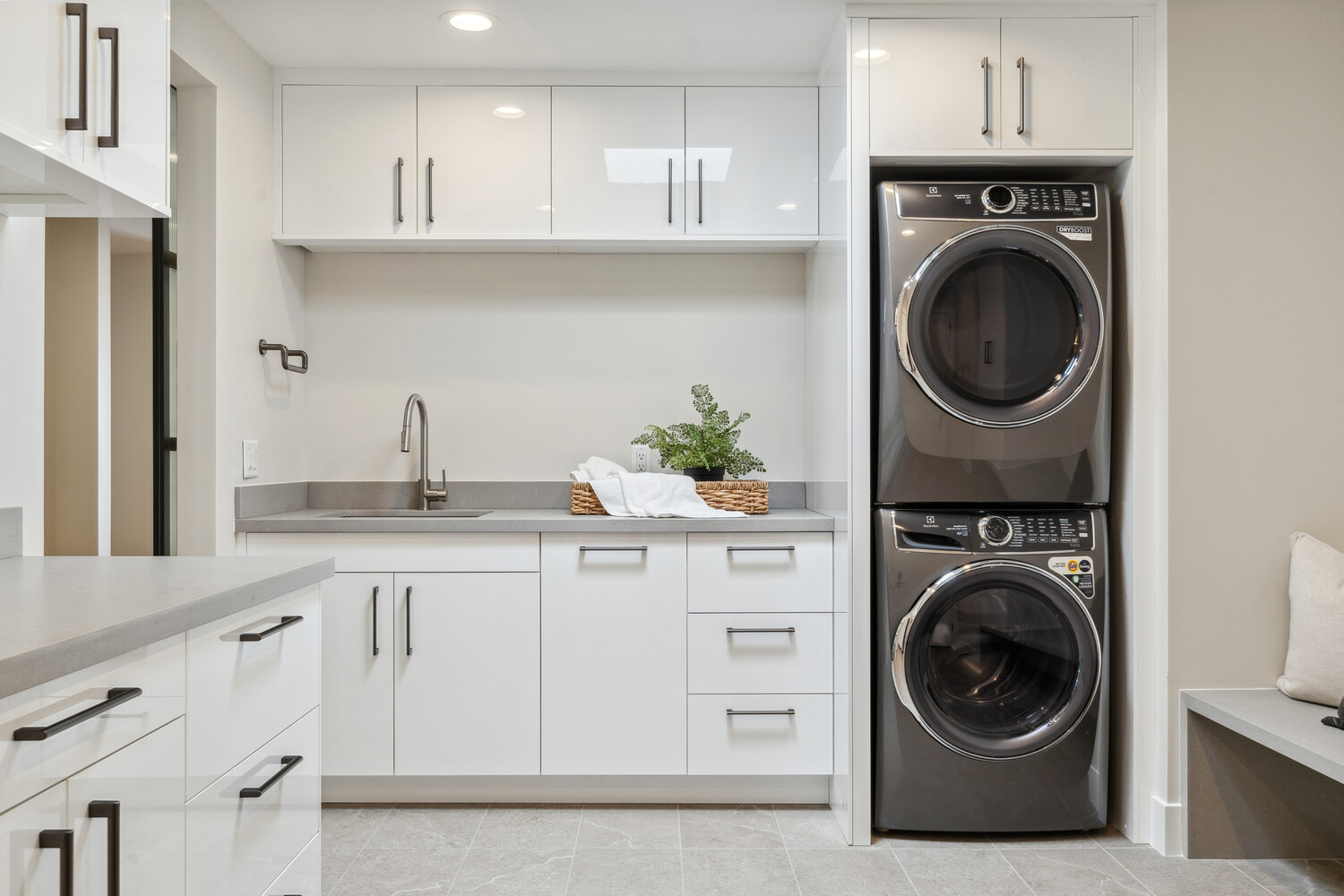 Stacked washer-dryer in modern laundry setup by Trinity Homes, part of Paradise Valley remodel