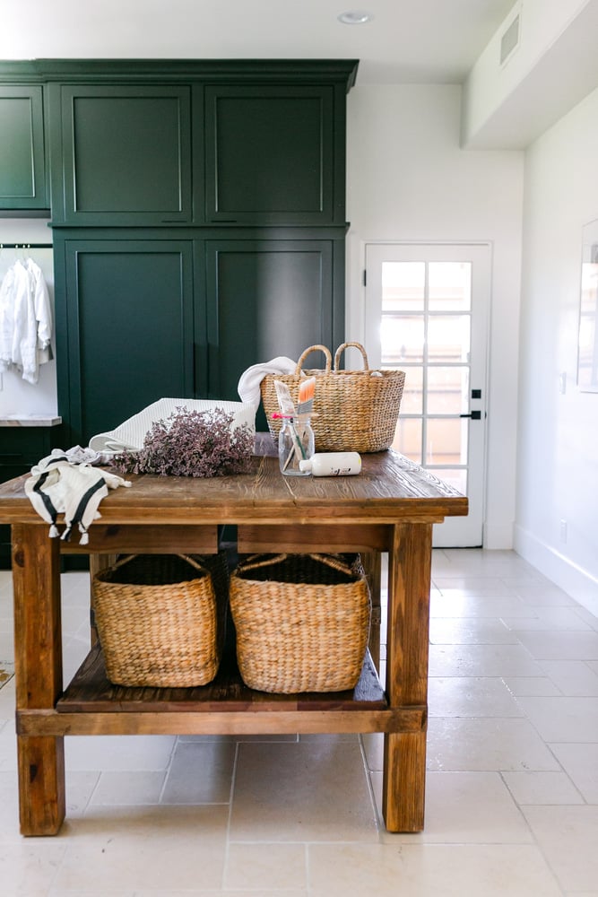 Trinity Homes Phoenix remodel showcasing rustic wood island and built-in storage baskets