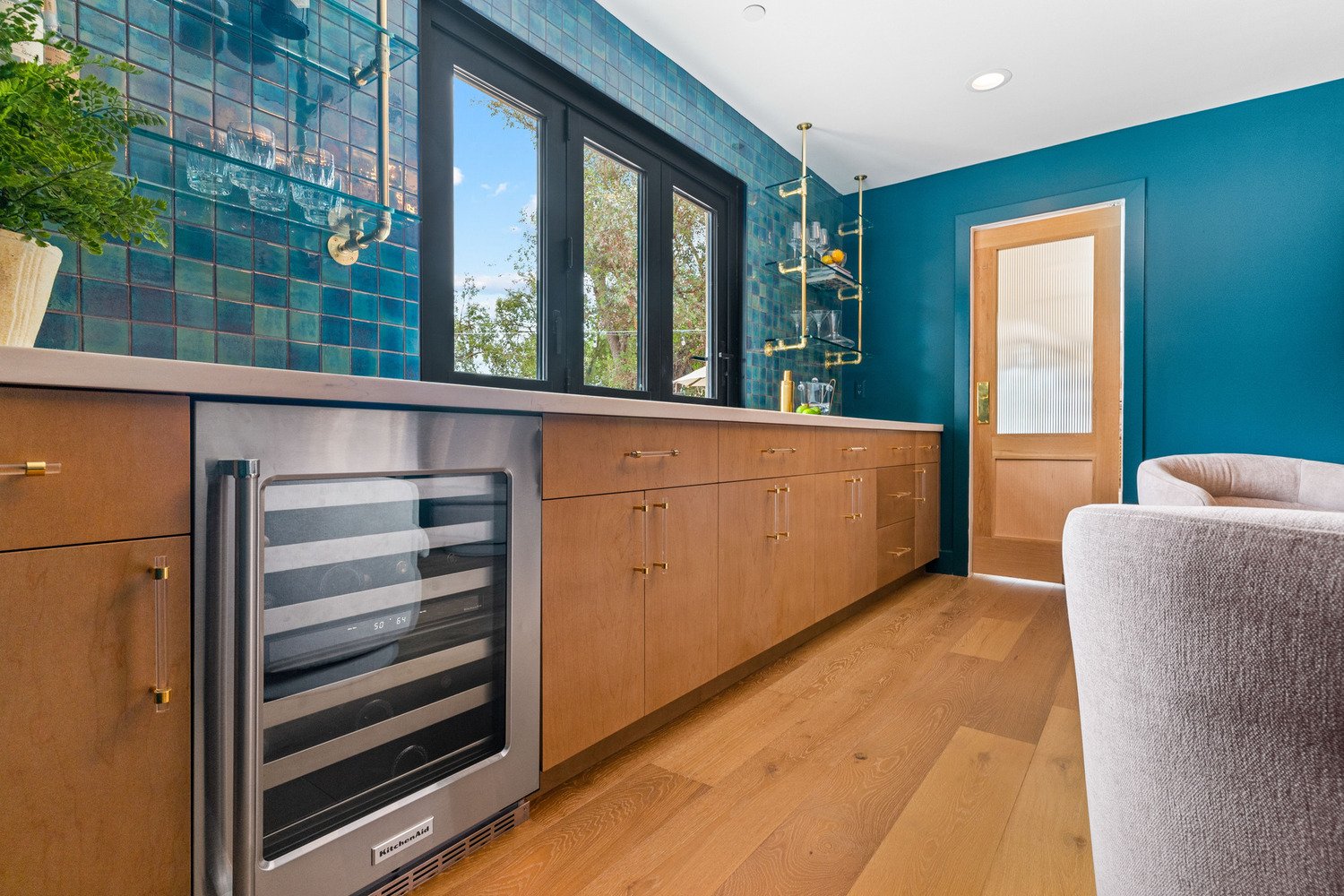Bar space with built-in wine cooler and teal backsplash in Scottsdale, AZ