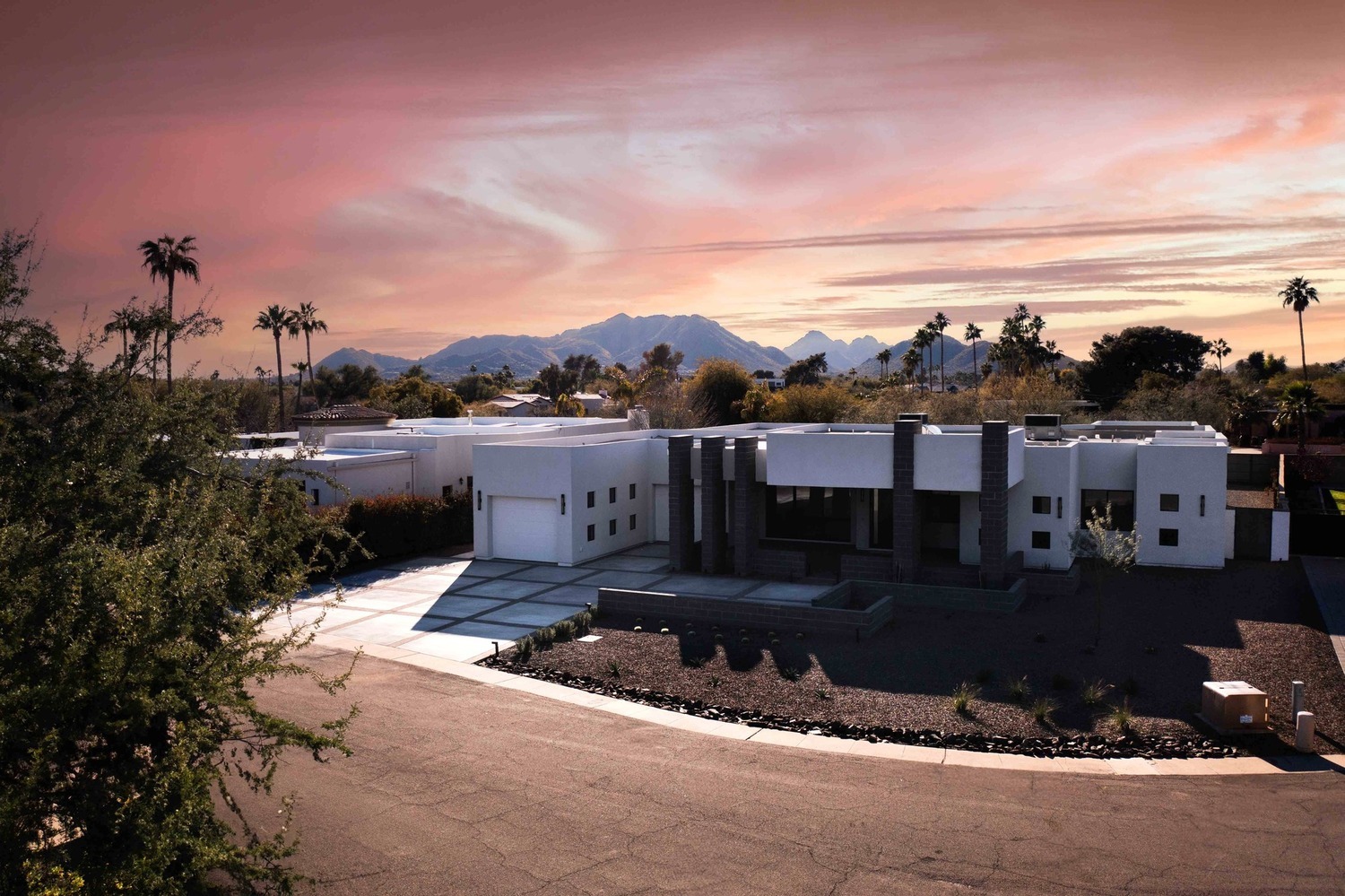 Modern home exterior with white stucco and black columns in Scottsdale, AZ