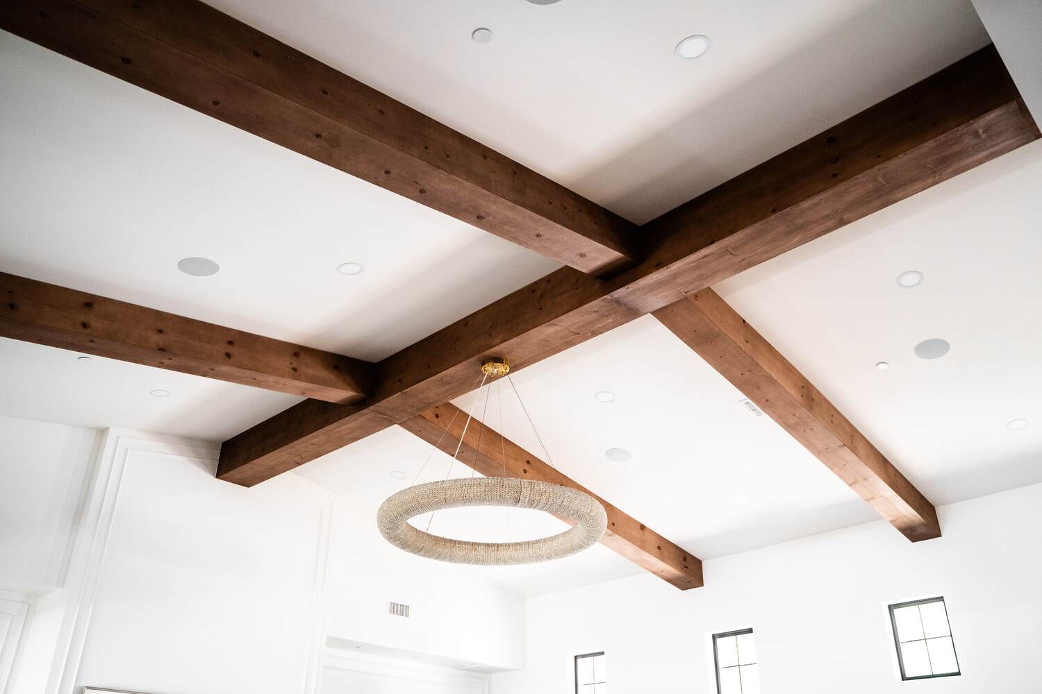 Wide view of ceiling beam and chandelier design in Trinity Homes’ Scottsdale, AZ renovation