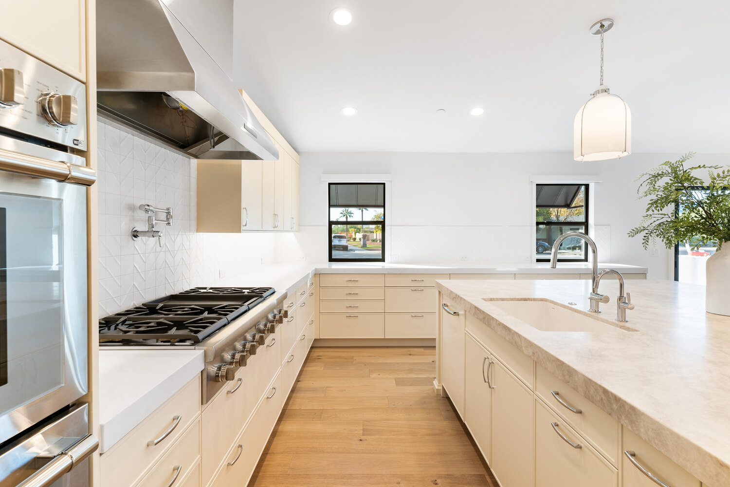 Clean white counters and ample storage in remodeled Scottsdale kitchen by Trinity Homes