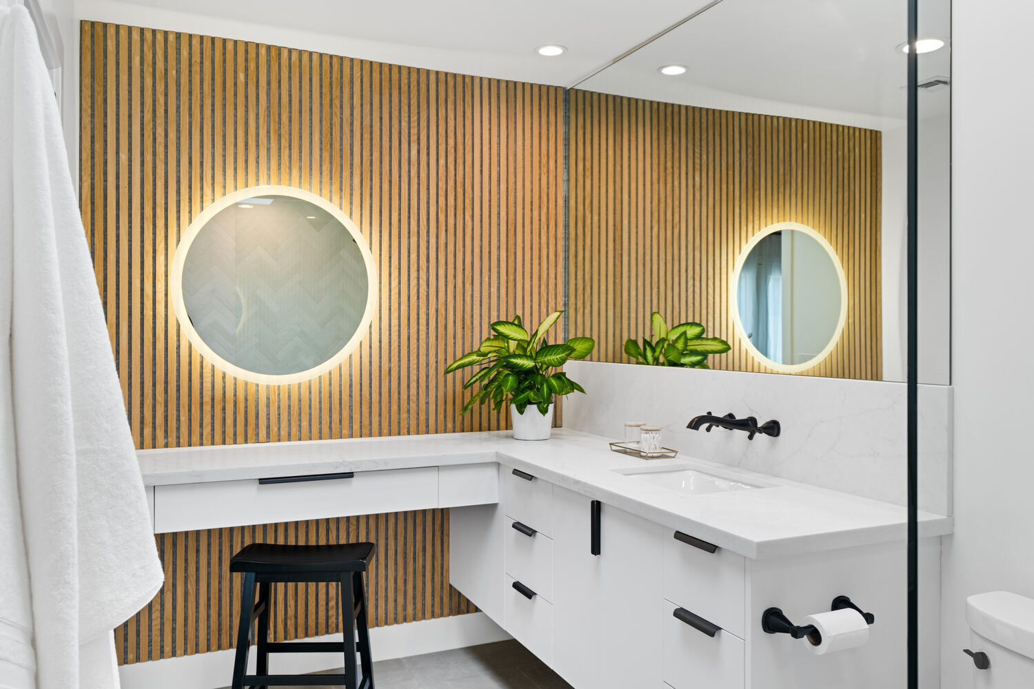 Full custom bathroom view with slatted wood wall and dual vanity by Trinity Homes AZ in Arcadia, AZ