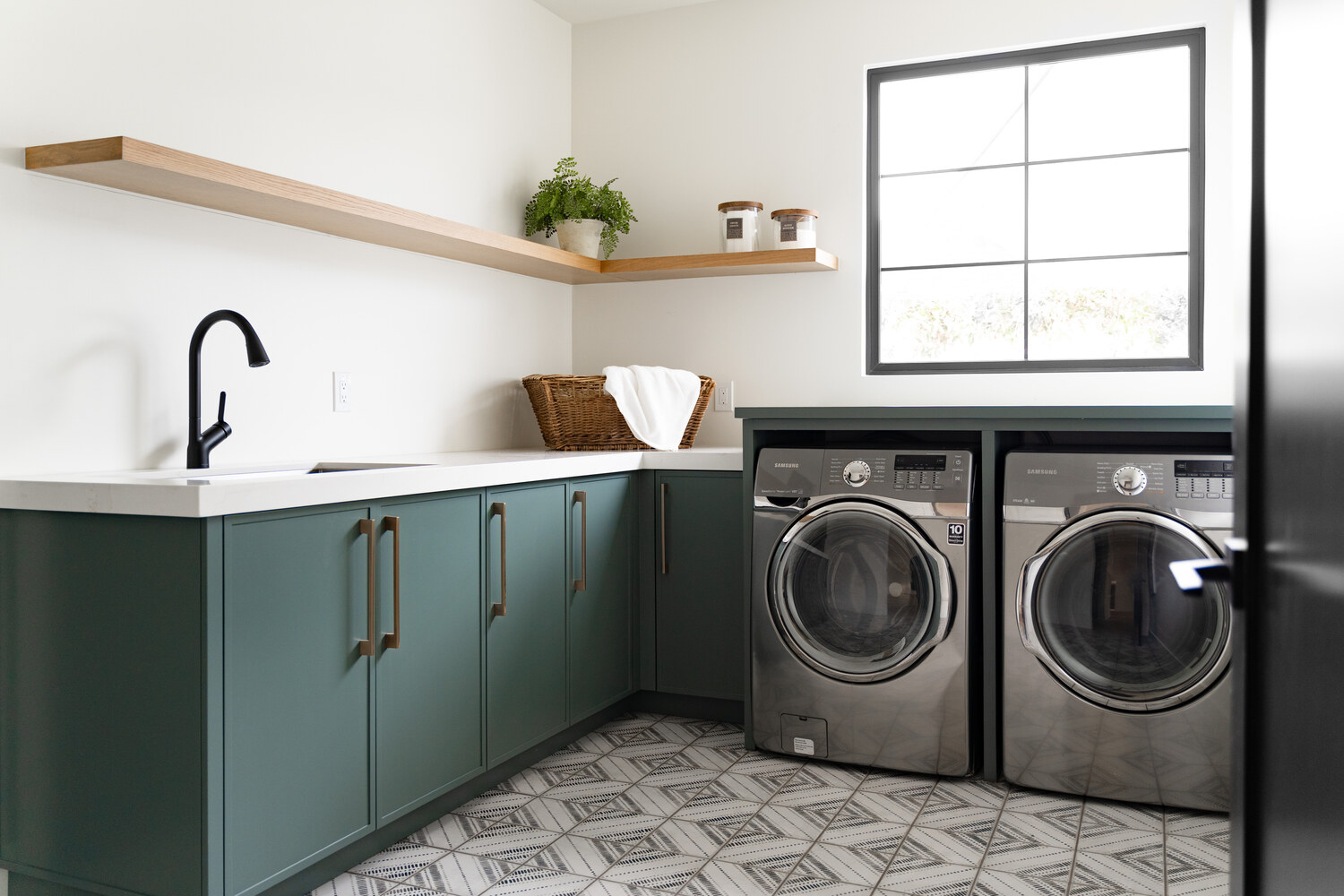 Functional laundry room with stylish storage and patterned tile flooring by Trinity Homes AZ, Scottsdale, AZ