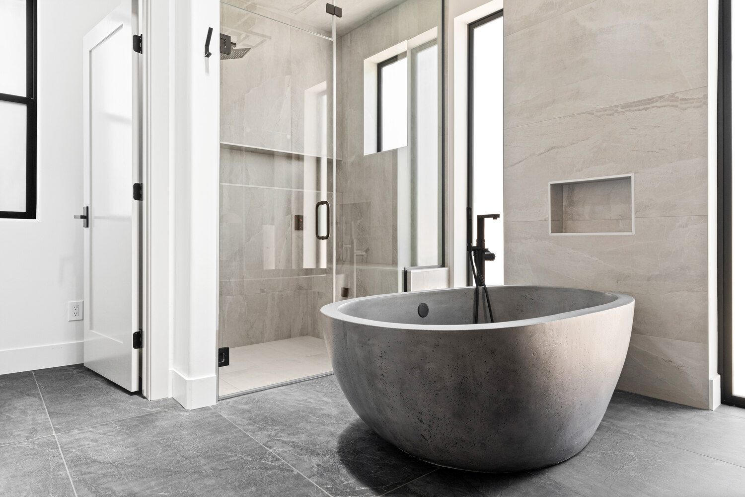 Trinity Homes AZ showcases spa-style luxury with a freestanding bathtub and glass shower in Tempe