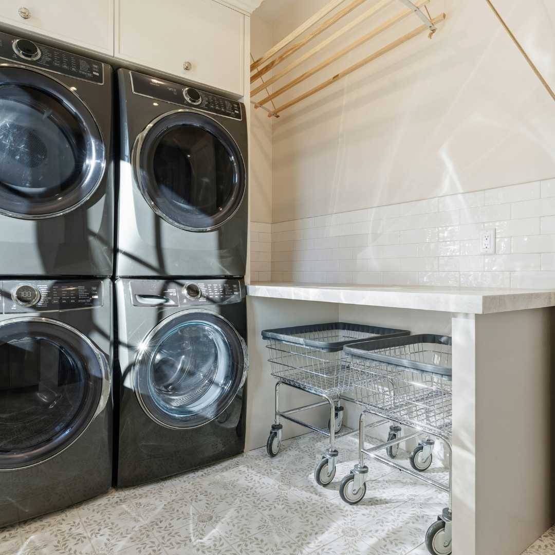 Laundry carts and washer and dryers in a custom home laundry room in paradise valley by Trinity Homes AZ